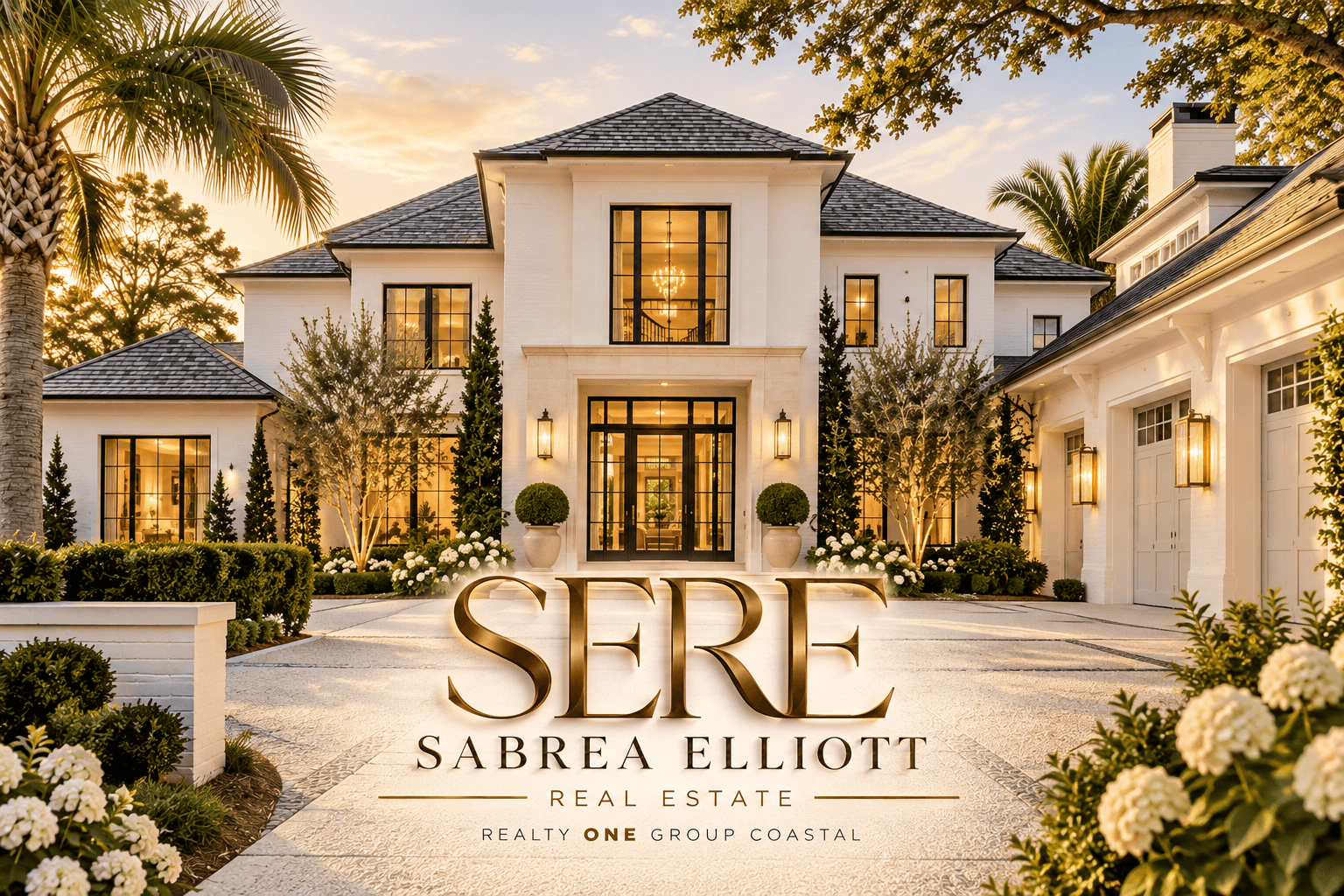 Luxurious white mansion at dusk with Sabrea Elliott Real Estate logo and manicured gardens.